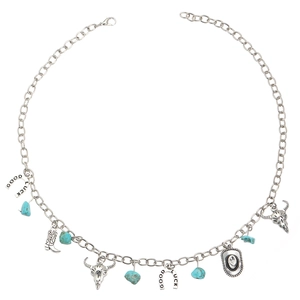 Detail of Western style necklace with Good Luck horseshoe, cow skull, and boot charms