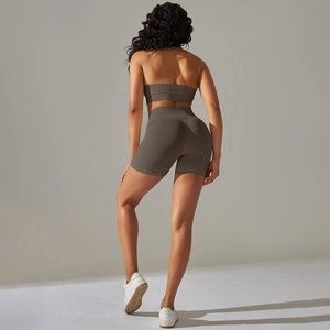 Detail of seamless ribbed olive green yoga set showing back view and premium fabric texture