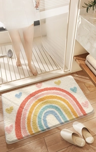 Close-up of rainbow heart pattern plush bathroom mat showing absorbent dense texture