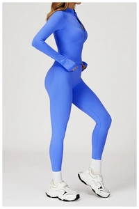 Detail of bright blue yoga jacket showing stand collar, zipper, and thumbhole cuffs
