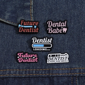 5-piece dentist themed enamel pin set with tooth designs and career slogans on denim fabric
