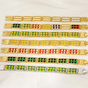 Detail of gold and silver steel bracelets with double-row colorful natural stone beads