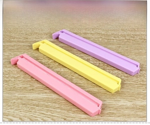 Macro detail of long PVC plastic snack clips in pastel colors with snap buckle
