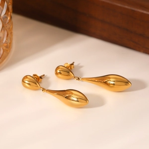 Detailed close-up of 18K gold plated stainless steel double teardrop earrings with a mirror finish