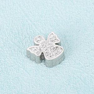 Polished silver angel pendant with sparkling rhinestones on light blue texture