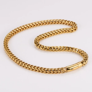 Close-up of golden stainless steel wheat chain necklace with rectangular clasp