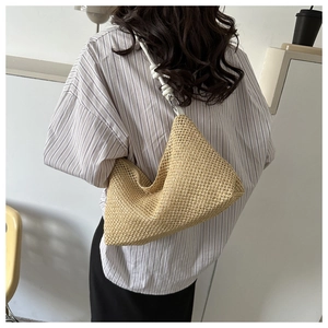 Detailed texture of hand-woven straw tote bag with elegant white knotted shoulder strap