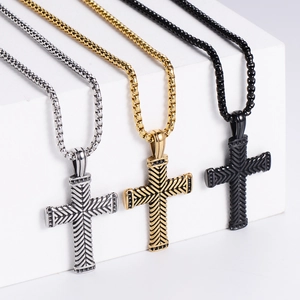 Detailed view of silver, gold, and black stainless steel cross pendants with twist chains