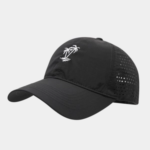 Close-up of coconut tree embroidery and laser-cut ventilation holes on a black quick-dry cap