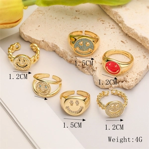 Detailed view of adjustable gold plated smile rings with zircon on light stone background