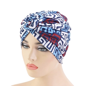 Women's ethnic style turban hat with colorful geometric prints and front twist knot flower