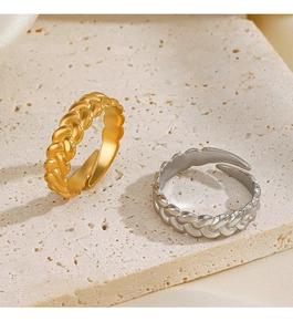 Detail of gold and silver braided twisted rings on stone and satin background