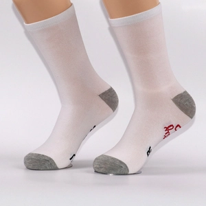 Detail of white cotton socks with gray heel and custom red and black embroidery on sole
