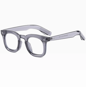 Macro shot of grey-purple transparent square frames with visible specs on inner temple