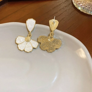 Detail view showing front and matte back of floral enamel drop earrings on white ceramic tray