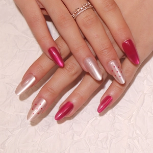 Deep magenta cat eye and champagne pointed fake nails with red polka dot accents