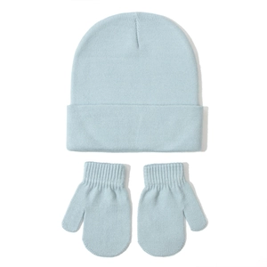 Detailed close-up of light blue knitted baby hat and mittens set with ribbed cuffs