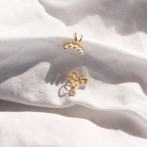 Elegant 14k gold plated clip-on earrings featuring five small white freshwater pearls