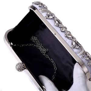Detail of luxury beaded evening bag with pearls, crystals, and silver chain strap
