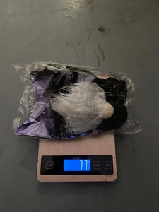 Weight measurement of Halloween faceless plush doll showing 77g on electronic scale