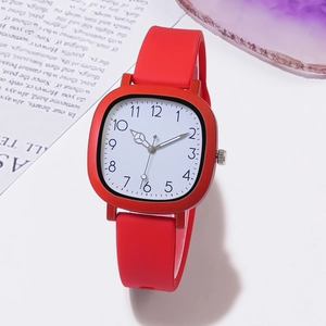 Detailed close-up of a square white dial watch with red silicone strap and Arabic numerals