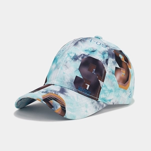 Detailed close-up of blue tie-dye baseball cap featuring brown digital print patterns
