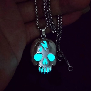 Luminous skull necklace with glowing lightning bolt design in a dark setting