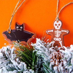 Halloween gift tags featuring cartoon bat and gingerbread skeleton with rustic twine strings