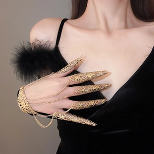Detailed macro view of exotic gold hollow flower nail ring finger bracelet with baroque carving