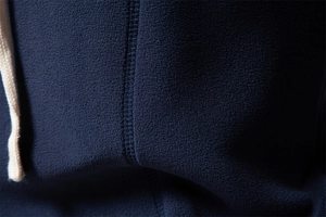 Detail of navy blue fleece fabric texture and premium white drawstring on hoodie