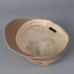 Interior detail of a breathable linen newsboy cap showing lining and quality label