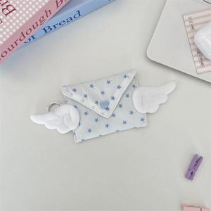 Detail of star pattern mini coin purse with plush wings and blue heart button buckle