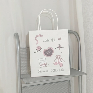 Detail view of a white paper gift bag with pink ballet theme illustrations and roses