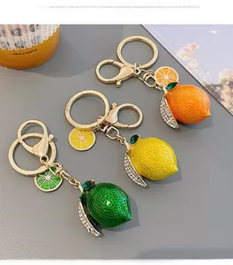 Detailed view of colorful lemon keychains with textured skin and rhinestone leaves