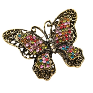 Vintage gold butterfly brooch with colorful crystals and intricate filigree details