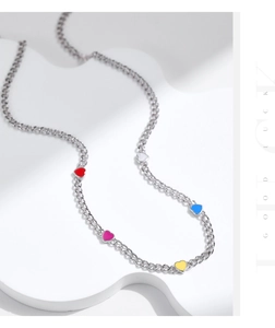 Detailed shot of s925 silver choker with colorful heart pendants on geometric stand