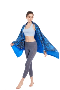 Quick-dry microfiber beach towel with navy bohemian pattern worn over shoulders