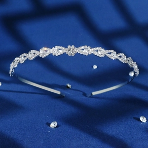 Elegant silver crown headband with sparkling rhinestones and teardrop crystals on blue velvet