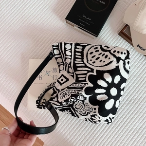 Close-up of bohemian canvas tote bag with abstract floral prints and leather straps