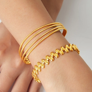 Golden titanium steel geometric beaded stacking bracelets for a minimalist layered look