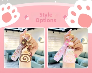 Close-up of cute cartoon cat Swiss roll cake keychain with Yummy strap and golden hardware