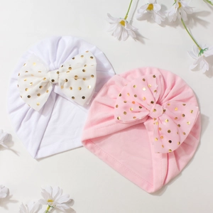 Infant headwrap caps with large gold polka dot bows in pink and white colors