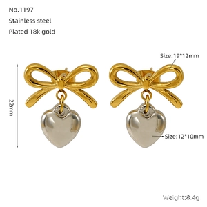 Detail view showing dimensions of two-tone stainless steel bow and heart earrings