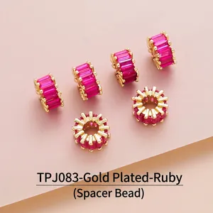 Close-up of gold-plated barrel beads with micro-pave red zircon for DIY jewelry