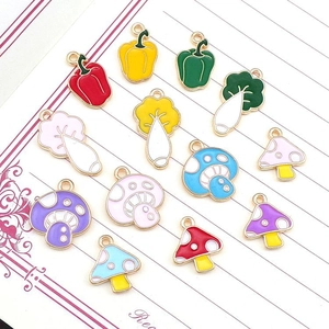 Enamel fruit and vegetable charms set including mushrooms, radishes and peppers on paper