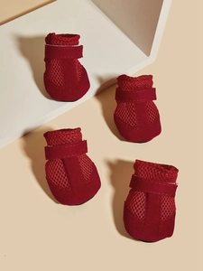 Detailed close-up of burgundy mesh dog shoes with suede texture and velcro straps
