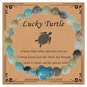 Detailed shot of handmade turquoise turtle bracelet on a Lucky Turtle poem card