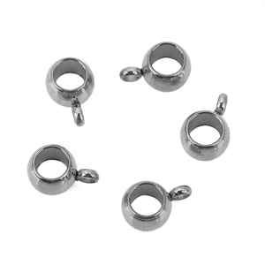 Detailed macro view of five polished silver stainless steel jewelry charms with loops