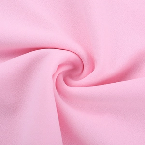 Macro shot of pink fabric texture showing fine grainy weave and soft drape of the dress