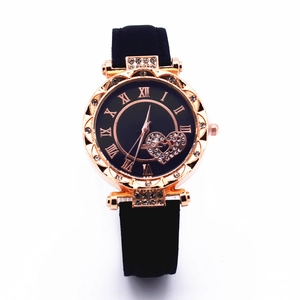 Detail of rose gold ladies watch with heart-shaped diamond-set black dial and roman numerals